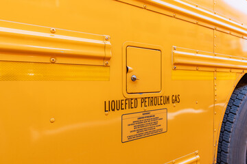Side of a parked yellow LPG, Liquefied Petroleum Gas,  school bus