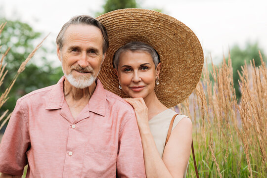 Portrait of a mature couple standing on a wheat field