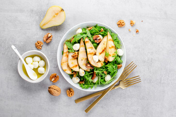 Grilled Pear Salad, Salad with Pear, Arugula, Mozzarella Pearls, Walnuts and Dressing over Bright...