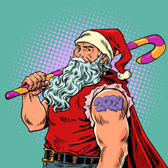 santa claus christmas The upcoming new year 2024 in the form of a tattoo on the shoulder of a man. Upcoming changes should be met with sweets. Brutal Santa Claus holds a huge lollipop in his hand and