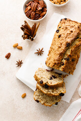 Fruitcake with cranberry, almond and pecan nuts sliced on a wooden board