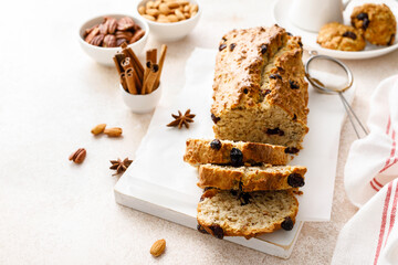 Fruitcake with cranberry, almond and pecan nuts sliced on a wooden board