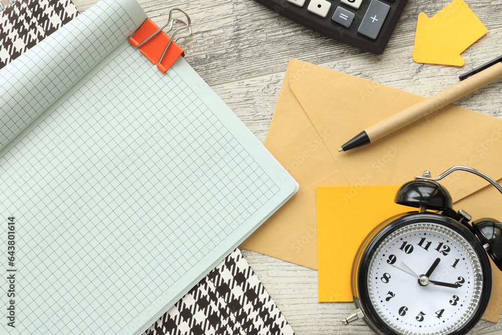 Poster top view of notebook page corner.desk clock.copy space, flat lay. business and finance concept.