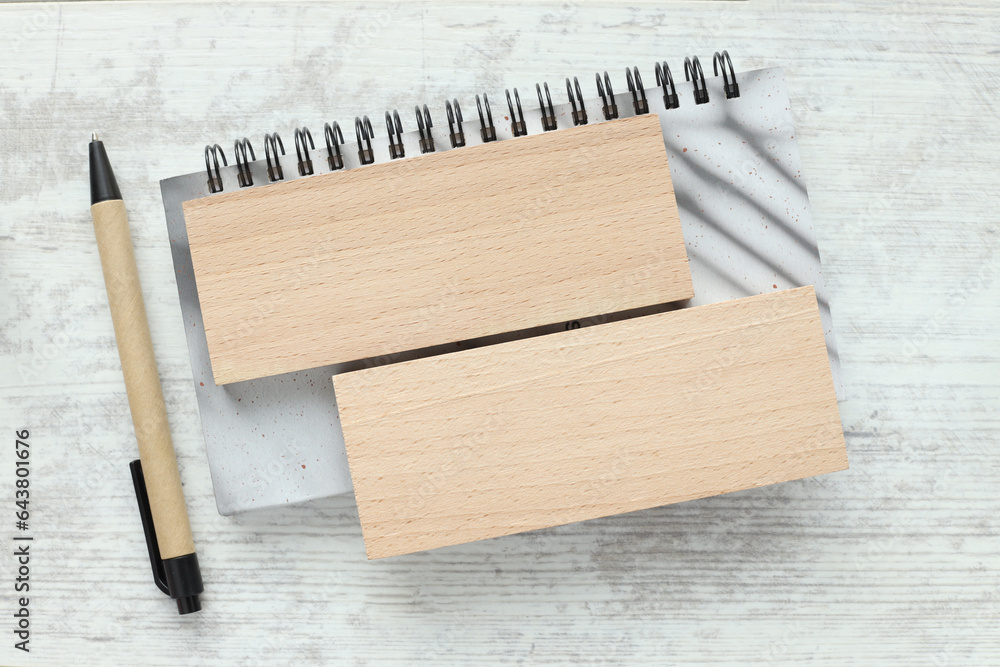 Aufkleber wooden block on a gray spiral notepad. notebook on the table. close-up