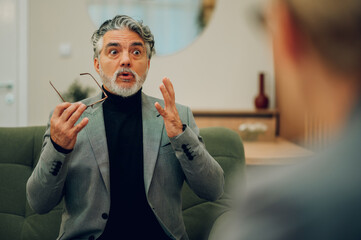 A frustrated senior male is expressing his discontent in the doctor's office.