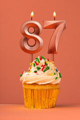 Candle number 87 - Cake birthday in coral fusion background