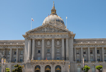 San Francisco, CA, USA - July 12, 2023: Gray stone City Hall east facade pediment above entrance...