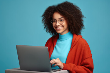Woman wearing red cardigan is seen using laptop. This image can be used to illustrate technology, remote work, or online communication.