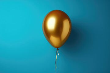 Golden balloon floating against vibrant blue background. Perfect for celebrations and adding touch of elegance to any design.
