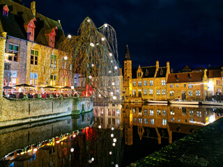 Christmas night idyllic canal reflection. Bruges, Belgium