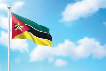 Waving flag of Mozambique on sky background. Template for independence