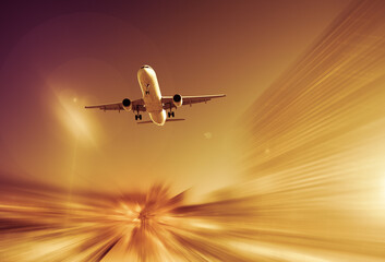 Fototapeta na wymiar Big airplane taking up motion in sky on landscape blurred background