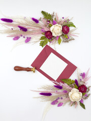 Flatley of natural flowers, burgundy envelope and greeting card, seal on white background, top view, space for text. Decor. Welcome card. High quality photo