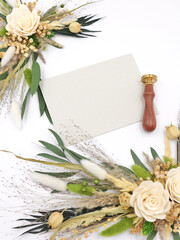Flatley of flowers and greeting card, seals on white background, top view, space for text. Holiday decor, welcome card. High quality photo