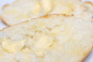 close up of a bread with butter. bread and butter with selective focus. sliced ​​bread with butter.