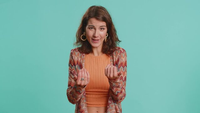 Need some more, please give me, help. Woman showing a little bit gesture with sceptic smile, showing minimum sign measuring small size. Pretty brunette girl isolated alone on blue studio background