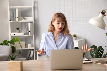 Young woman having job interview online at home