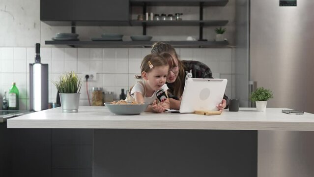 small girl toddler and mother or aunt play with finger puppets at home