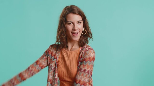 I am strong and independent. Young woman showing biceps and looking confident, feeling power strength to fight for rights, energy to gain success win. Girl isolated alone on blue studio background