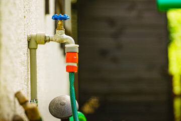 Garden tap with hosepipe attached.
