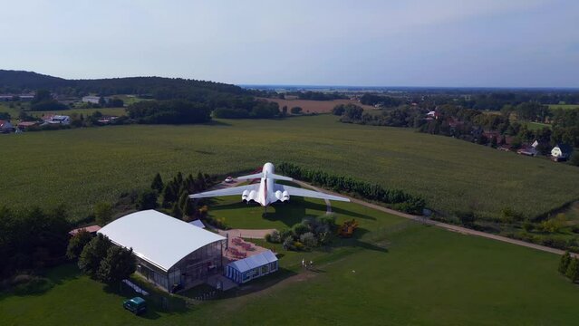Nice aerial top view flight drone. II-62 aircraft on ground. hilly summer fields