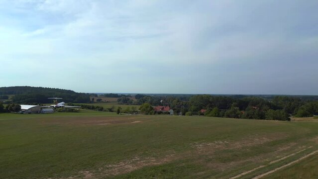 Magic aerial top view flight drone II-62 aircraft on ground. hilly summer fields