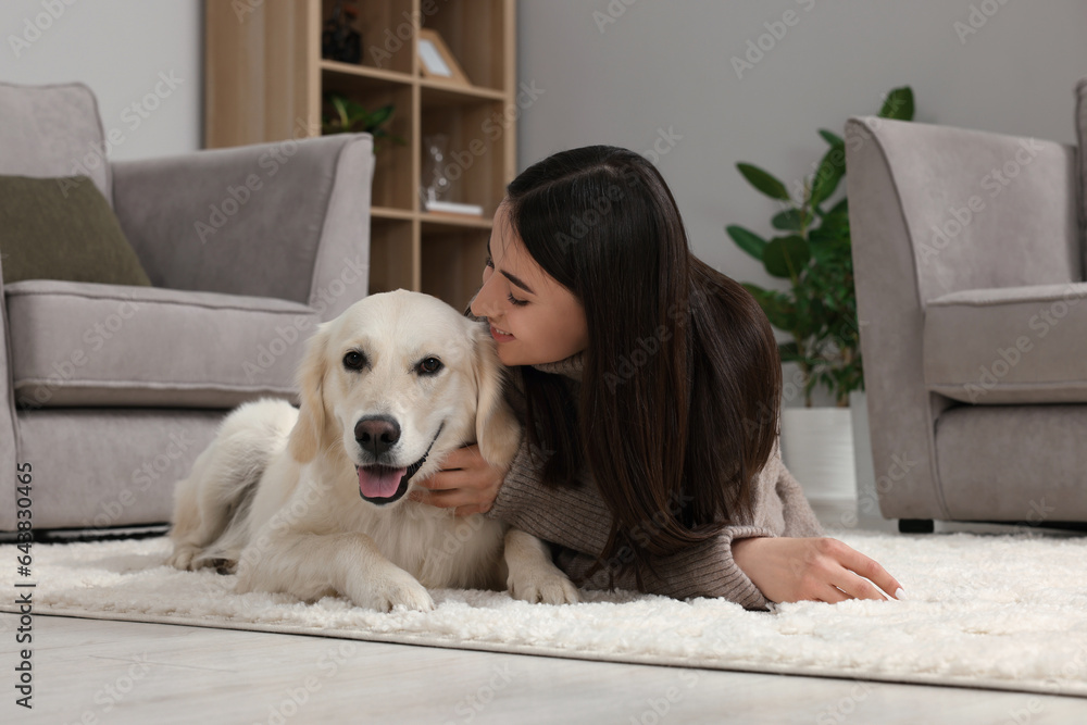 Sticker Happy woman with cute Labrador Retriever dog on floor at home. Adorable pet