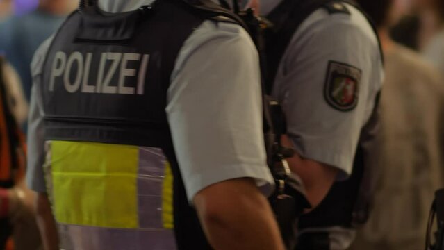 German Police Officers Filmed from Behind Patrolling an Event