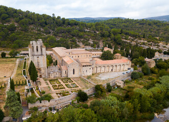 Aerial view of Romanesque Benedictine Abbey Sainte-Marie d'Orbieu in commune of Lagrasse in...
