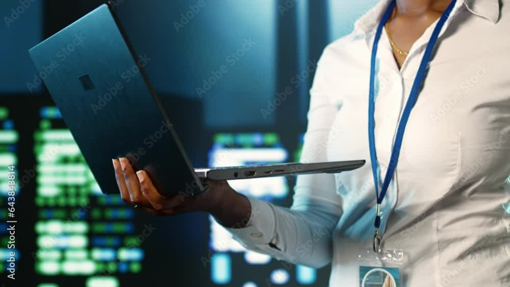 Poster employee strolling through data center hardware clusters providing processing resources for differen