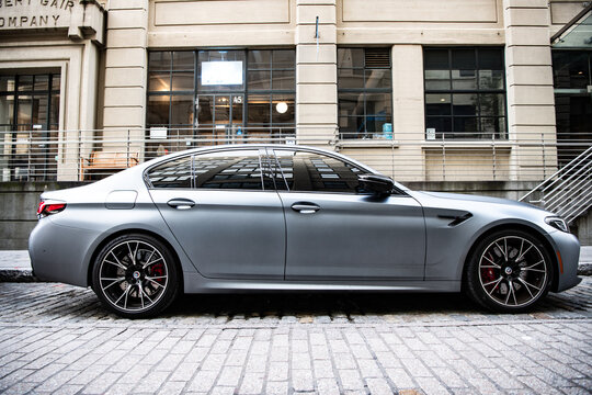New York City, USA - July 15, 2023: BMW F90 M5 grey color vehicle parked, side view