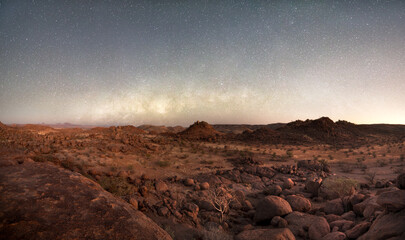 The Milkyway core sets over the boulder strewn landscape of Damaland, Namibia.
