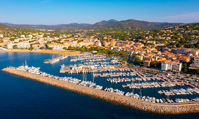 Summer aerial view of French coastal town of Sainte-Maxime on Mediterranean coast overlooking marina with moored pleasure yachts 