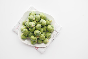 Fresh brussels sprouts in a box on a white background