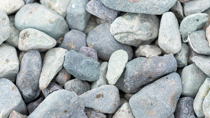 Grey small stone texture background on the beach.