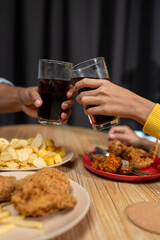 Group of happy asian young people celebrating clinking glasses drinks During a party in the living room of the home office Christmas or New Year's party lifestyle concept, study, work, holiday.