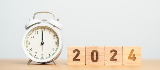 Happy New Year with vintage alarm clock and 2024 block. Christmas, New Start, Resolution,...