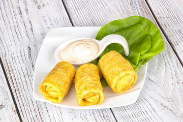 Stuffed pancakes with cream sauce