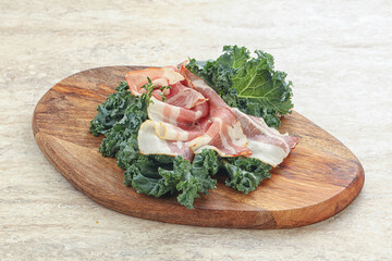 Raw pork bacon over board
