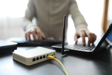 Modern dual band wireless router. Man working in the background. Fast and wireless internet concept.