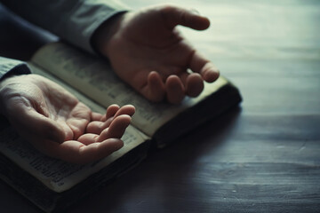 Reading religious literature. A man studies the Koran and sorts out the rosary.