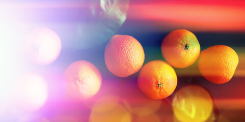 Abstract background of tangerines with leaves. Citrus fruits on the table. Christmas fruit.