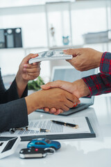 Handshake, Businessman completes successful car purchase transaction by give car keys after...