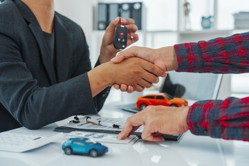 Handshake, Businessman completes successful car purchase transaction by give car keys after...