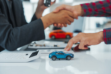 Handshake, Businessman completes successful car purchase transaction by give car keys after finalizing contract signing, great investment, handover of keys, satisfaction purchase new or used vehicle