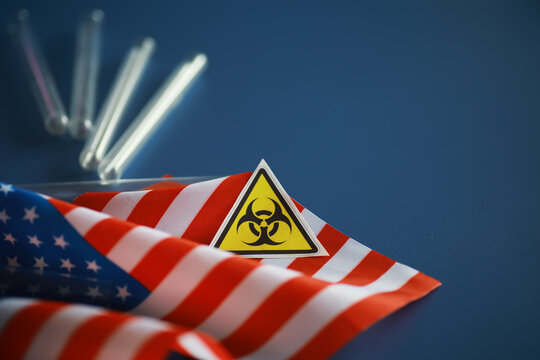American flag and biohazard sign. The concept of American biolabs and research centers.