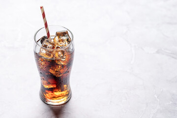 Refreshing glass of cola with ice