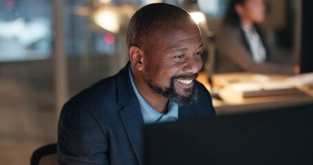 Reading online, thinking and happy black man at computer in office with email, report or review at night. Market research, smile and business insight at overtime and businessman checking web article.