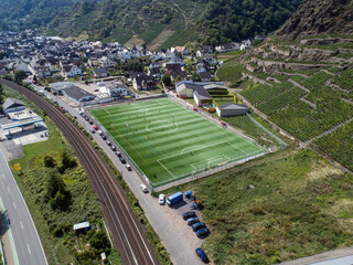Aerial view of a big sports and soccer football field in a village near Winningen at the moselle river in Germany