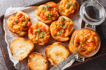 Bread with homemade caviar vegetables eggplant, zucchini, tomatoes, onions, bell peppers and garlic. Horizontal top view from above